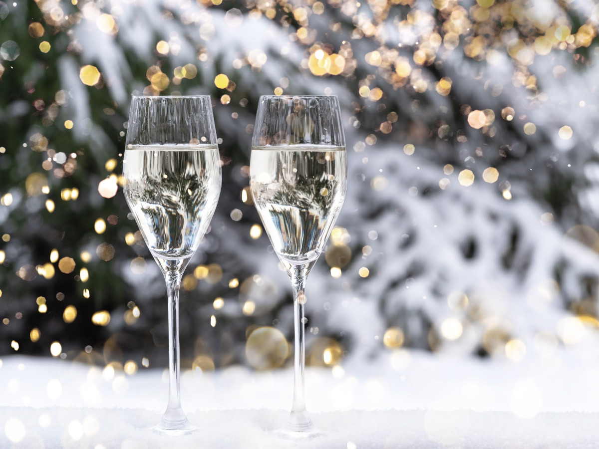 Two glasses of fizz with a winter background